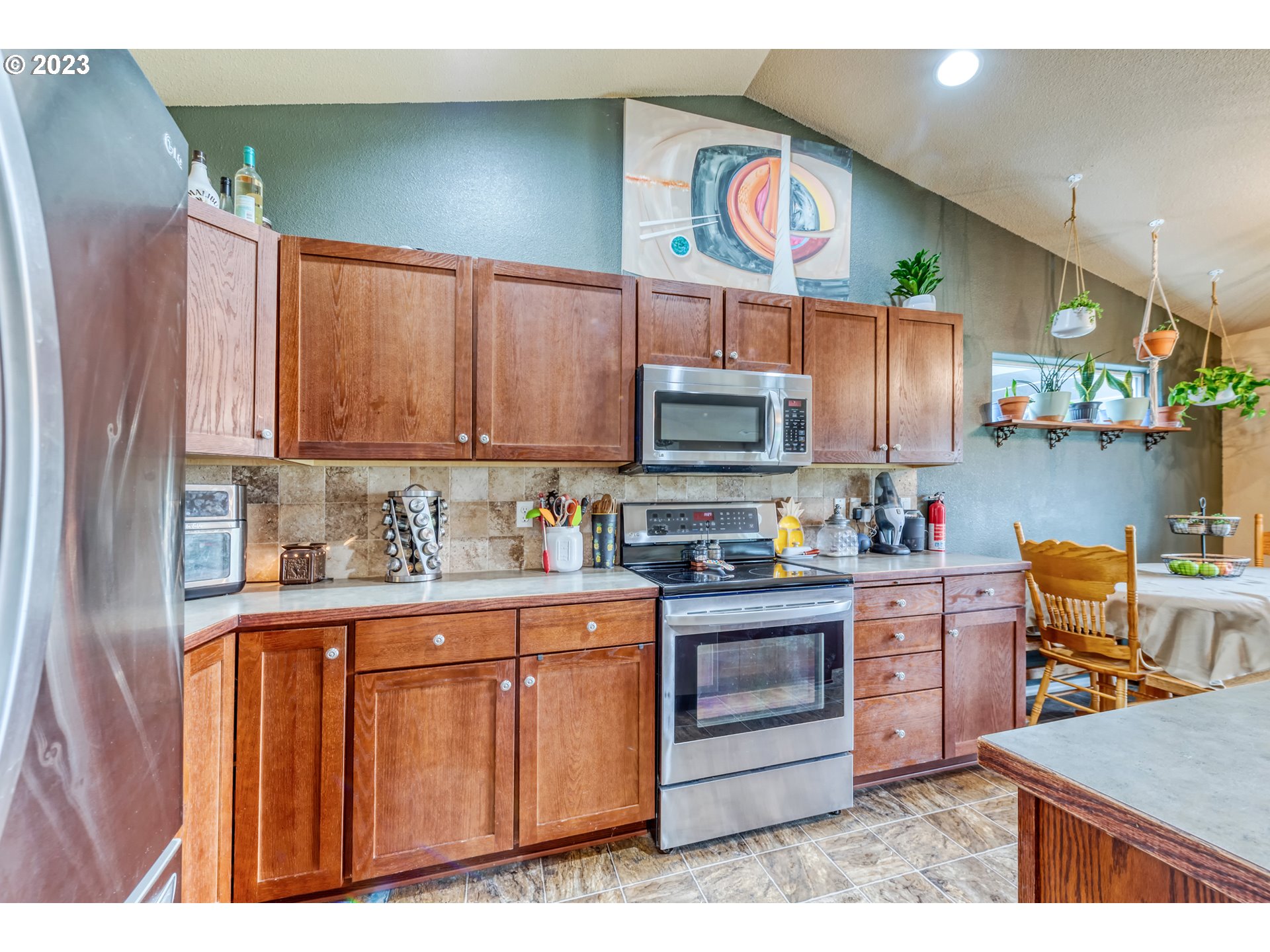 237 Rowan Street Roseburg, OR 97471 - Photo 12 of 35 a kitchen with stainless steel appliances granite countertop a stove top oven a sink dishwasher and cabinets with wooden floor
