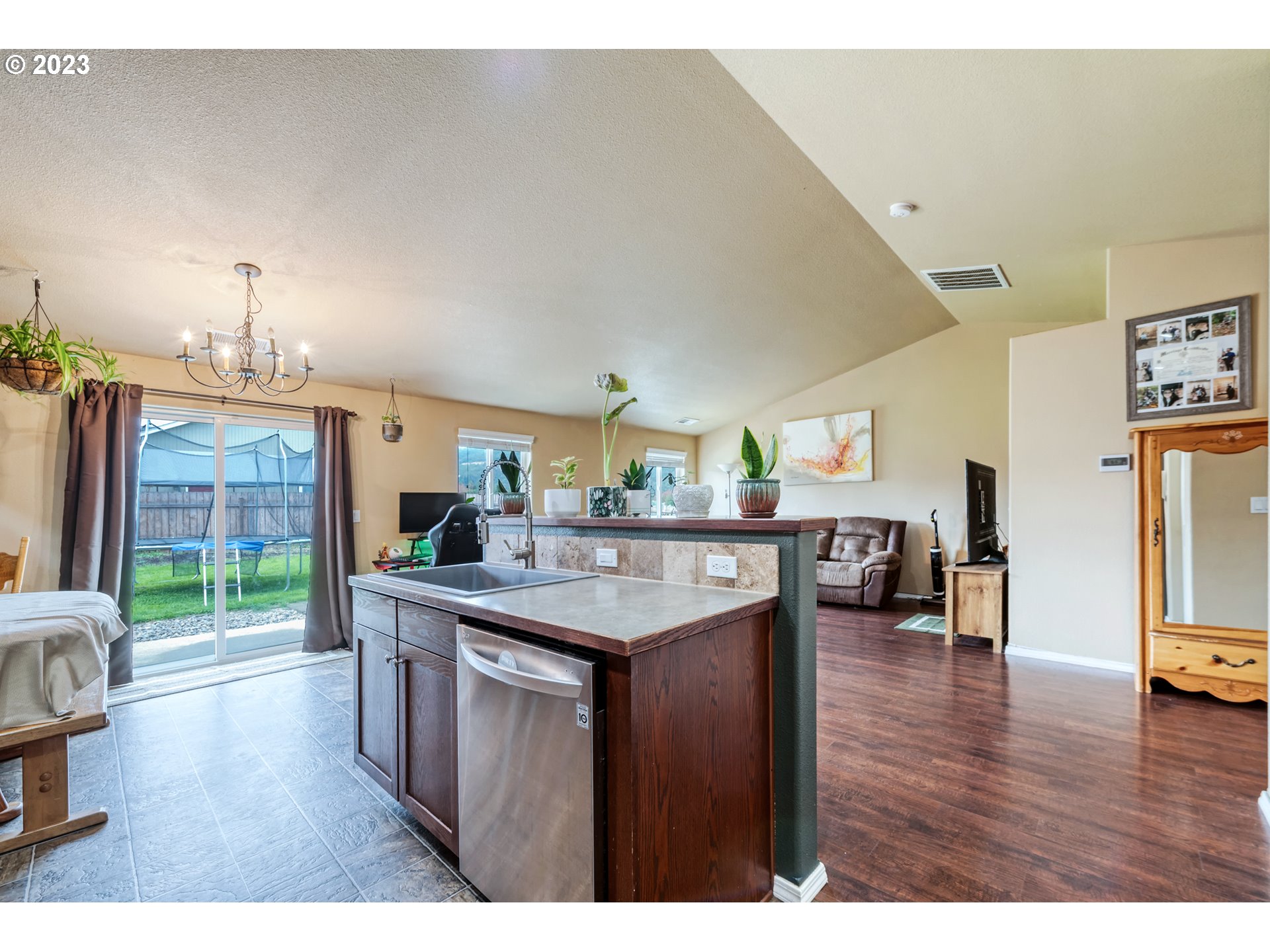 237 Rowan Street Roseburg, OR 97471 - Photo 13 of 35 a kitchen with stainless steel appliances granite countertop a stove and a wooden floors