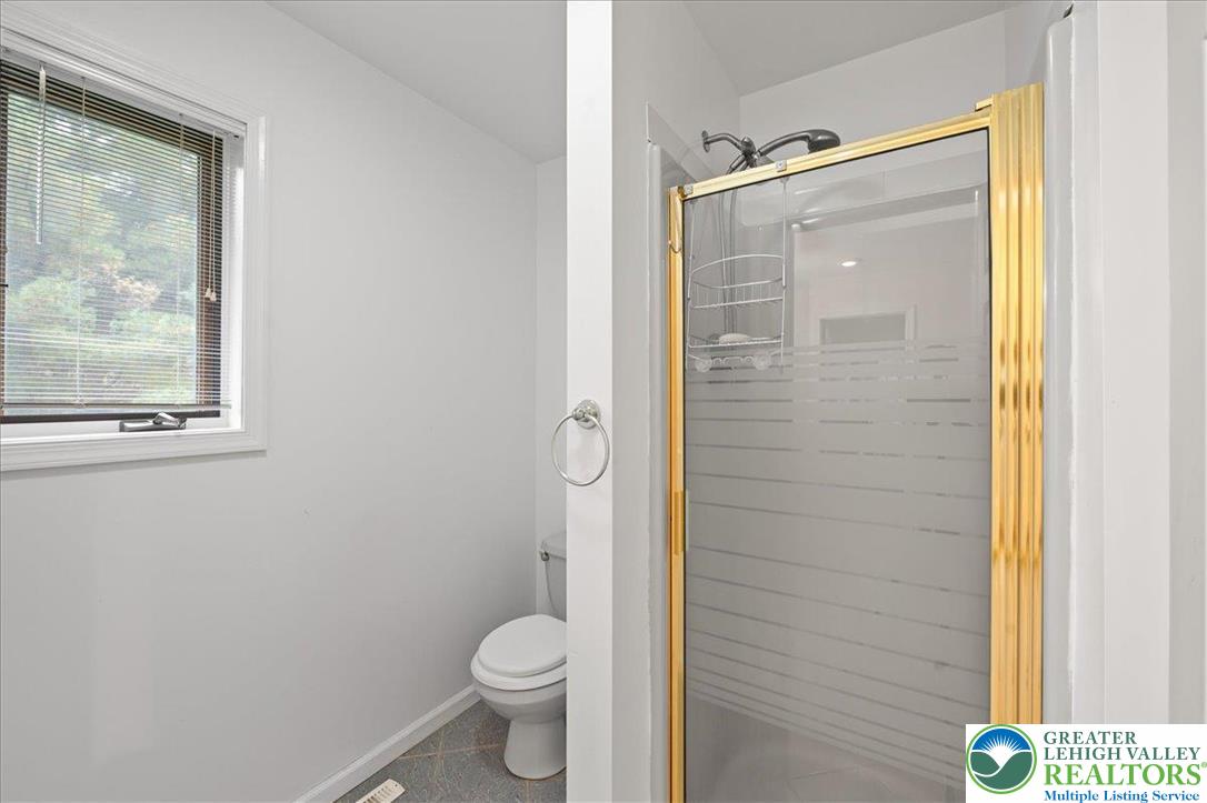 131 Stone Ridge Albrightsville, PA 18210 - Photo 26 of 51 a bathroom with a granite countertop toilet and a shower