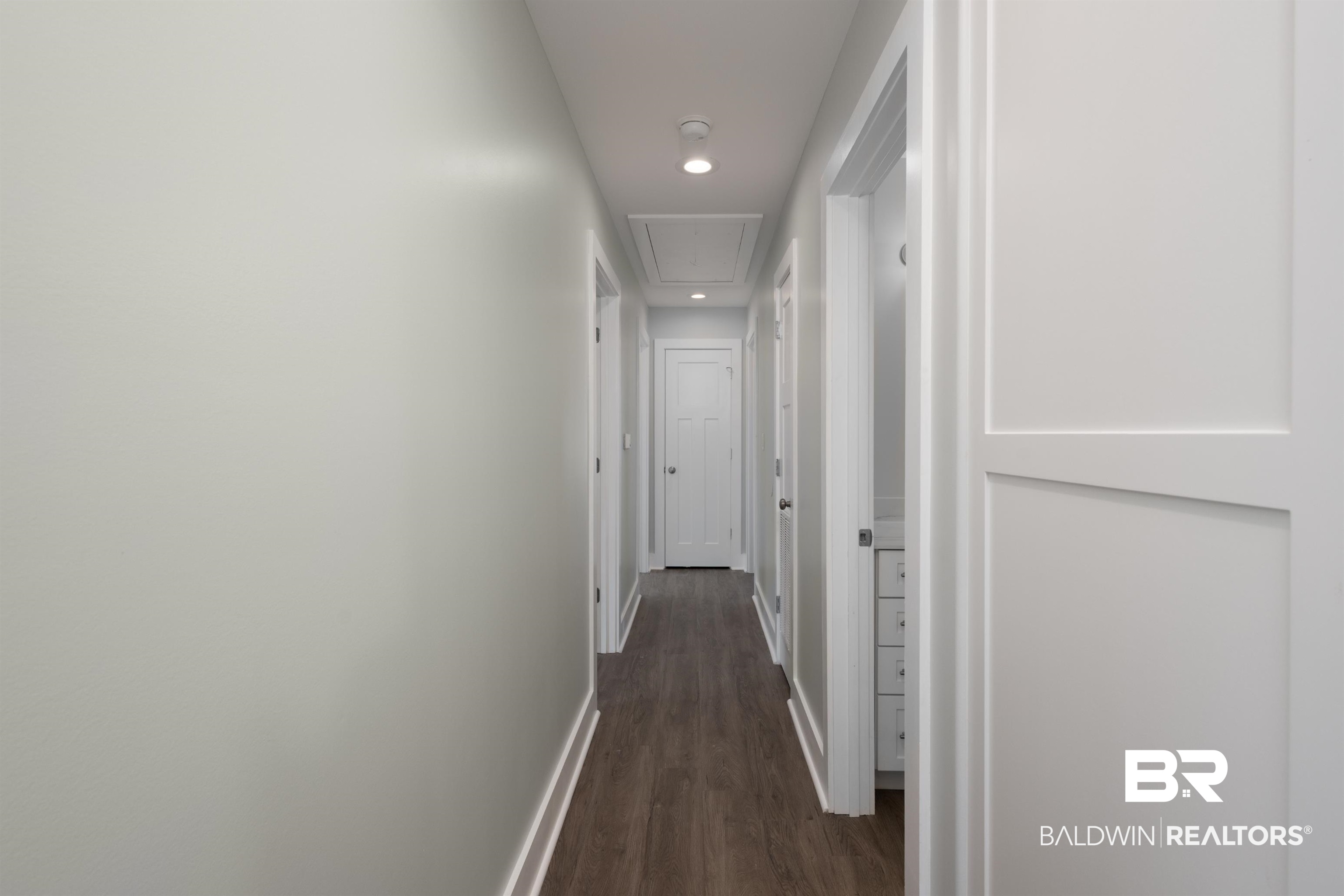 18267 Highway 98 Foley, AL 36535 - Photo 12 of 26 Hall featuring attic access, dark wood-style floors, and recessed lighting