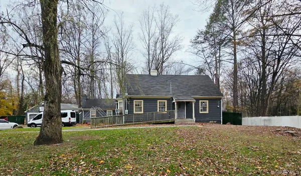 a backyard of a house with table and chairs