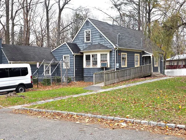 a front view of a house with a yard table and chairs