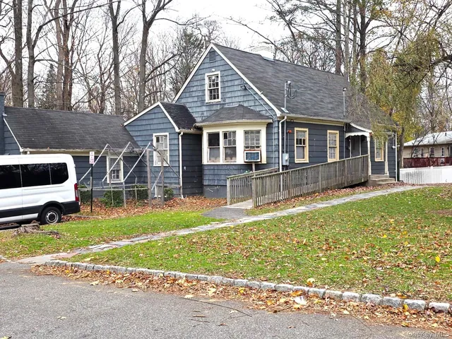 a front view of a house with a yard table and chairs