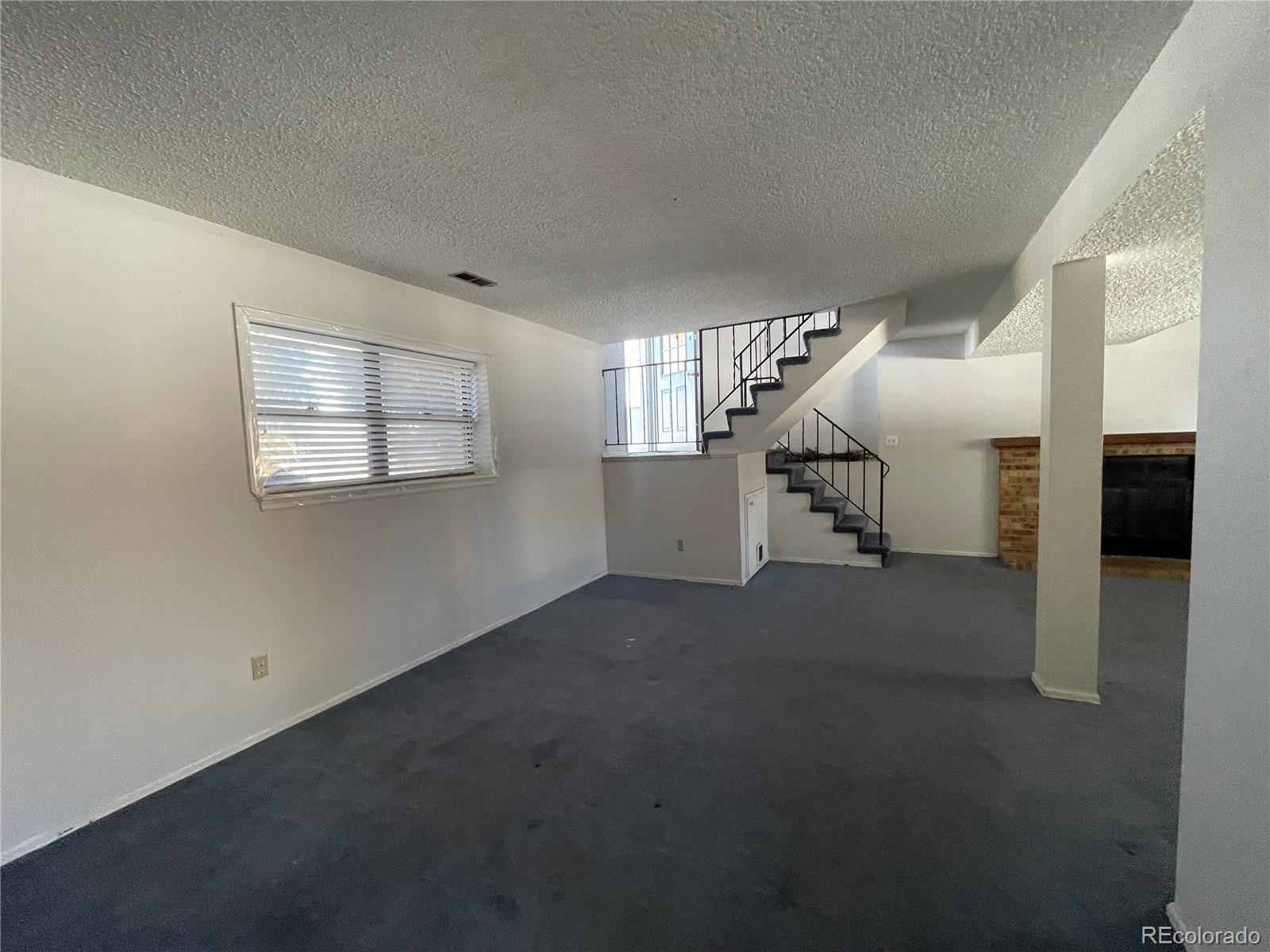 2955 Quincy Place Colorado Springs, CO 80916 - Photo 11 of 33 a living room with furniture and a window