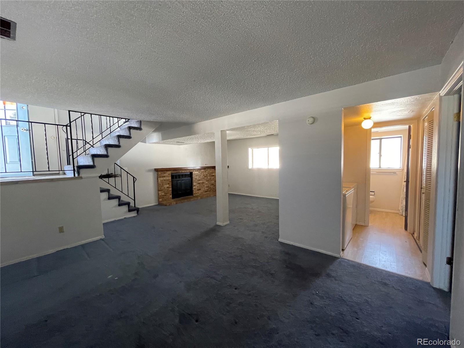 2955 Quincy Place Colorado Springs, CO 80916 - Photo 12 of 33 a view of a livingroom with furniture and staircase