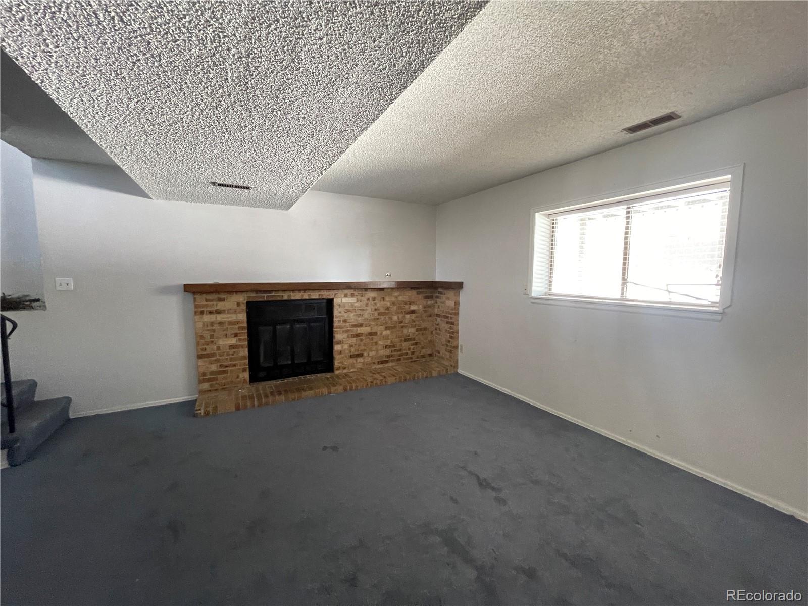 2955 Quincy Place Colorado Springs, CO 80916 - Photo 13 of 33 an empty room with a fireplace
