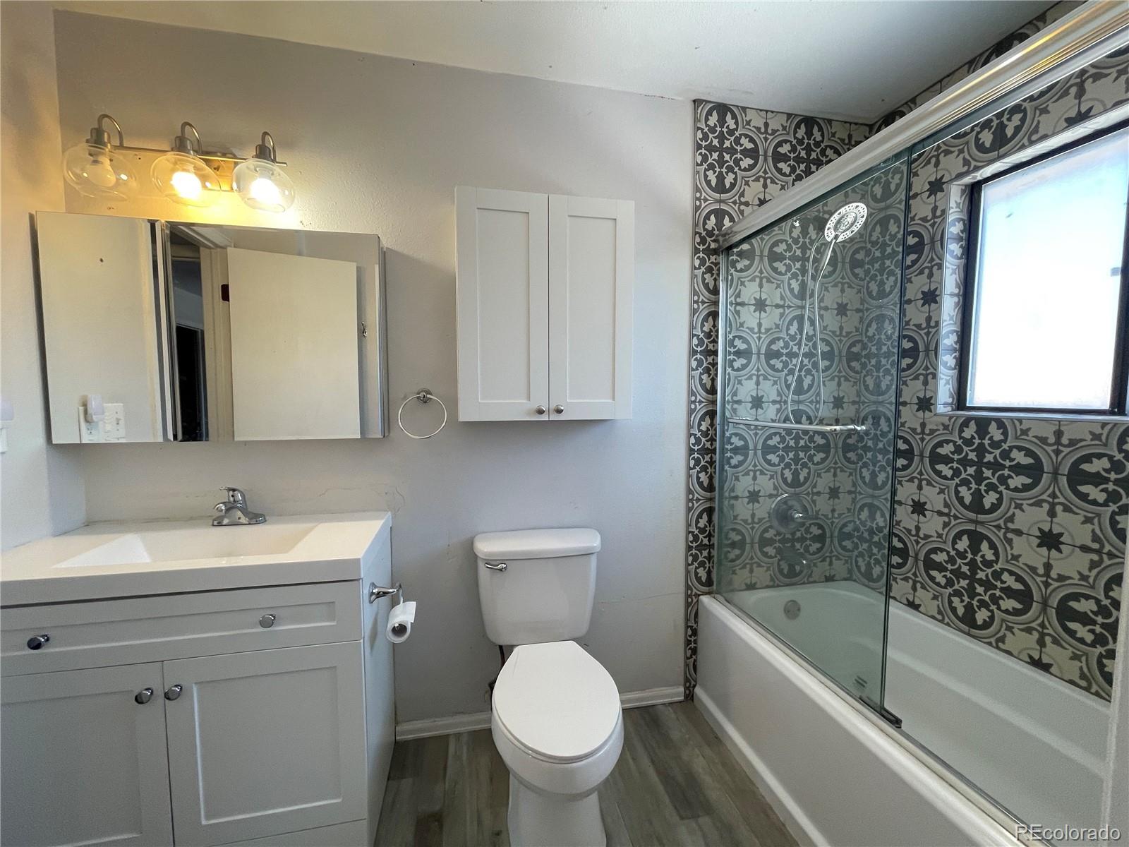2955 Quincy Place Colorado Springs, CO 80916 - Photo 20 of 33 a bathroom with a bathtub toilet sink vanity and mirror