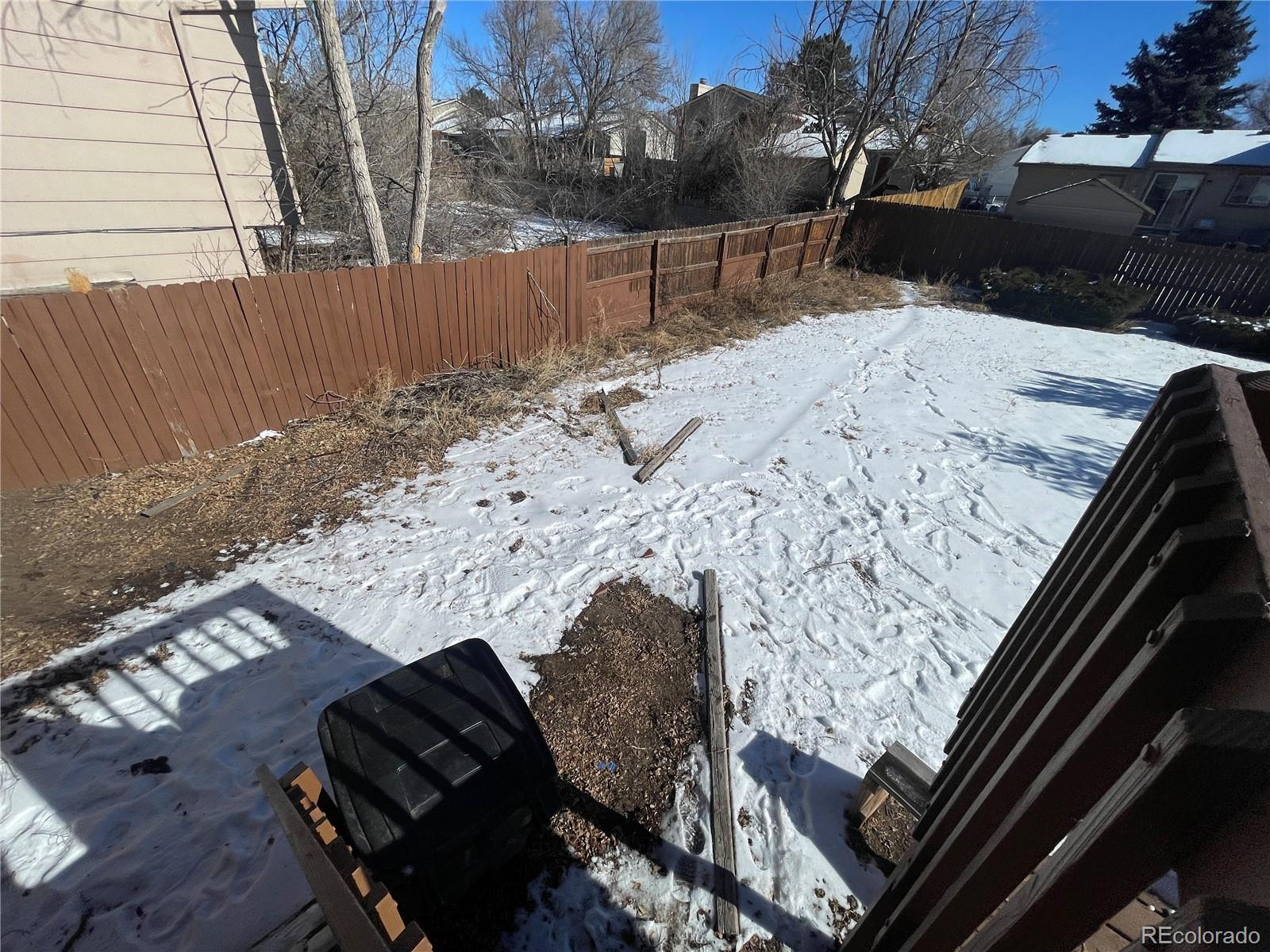 2955 Quincy Place Colorado Springs, CO 80916 - Photo 28 of 33 a view of a yard in the snow