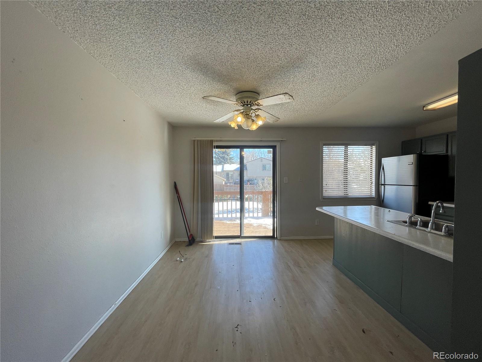 2955 Quincy Place Colorado Springs, CO 80916 - Photo 5 of 33 a view of an empty room with window and wooden floor