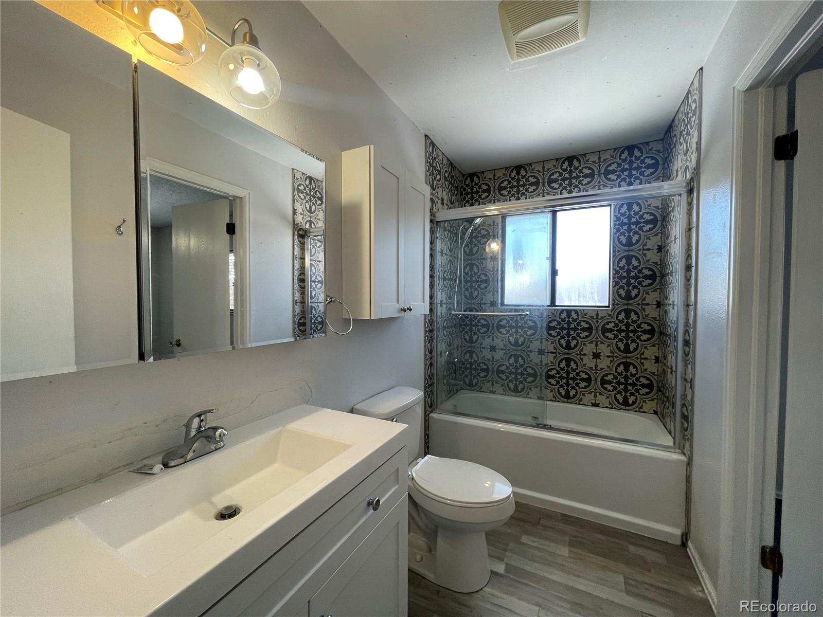 2955 Quincy Place Colorado Springs, CO 80916 - Photo 9 of 33 a bathroom with a bathtub shower sink vanity and toilet