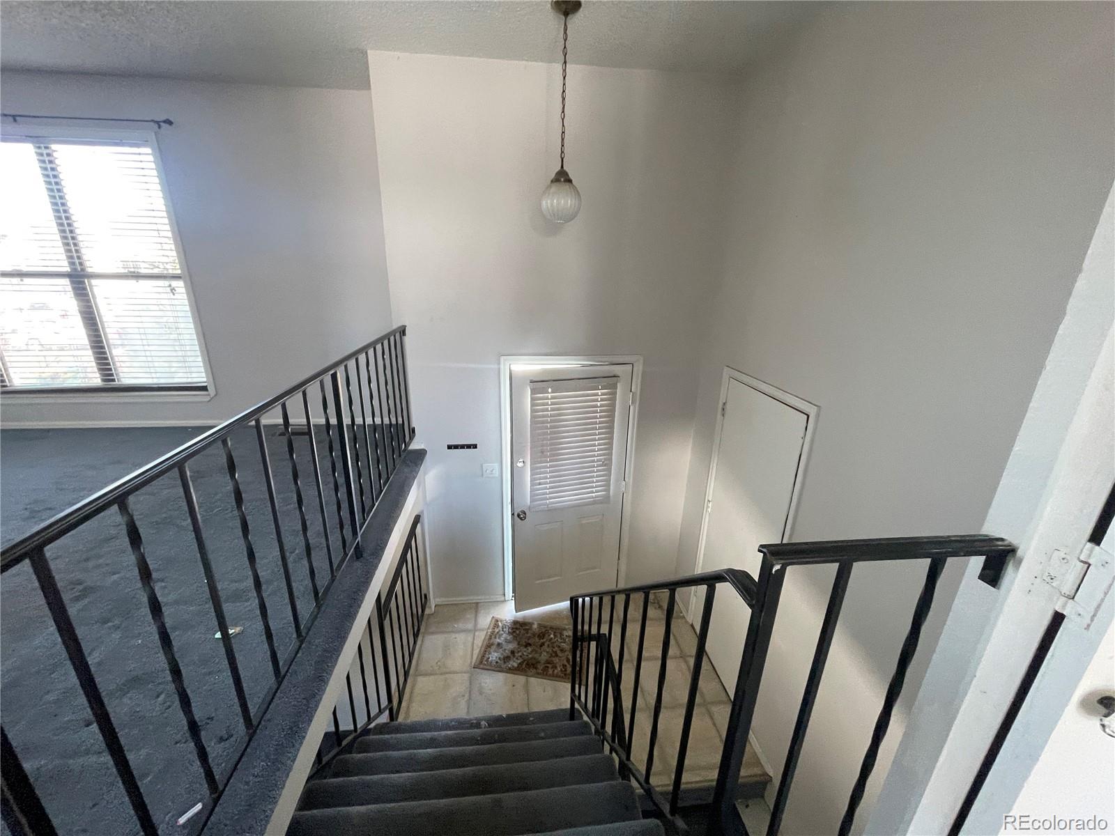 2955 Quincy Place Colorado Springs, CO 80916 - Photo 10 of 33 a view of staircase with railing and white walls
