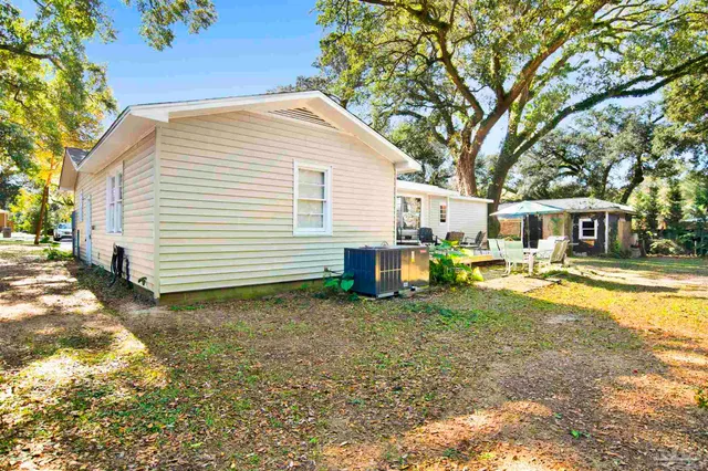 a view of a house with backyard and sitting area