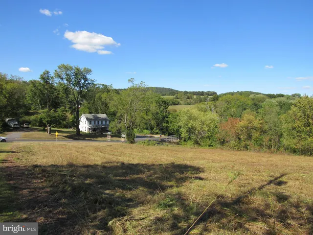 a view of a field with an ocean