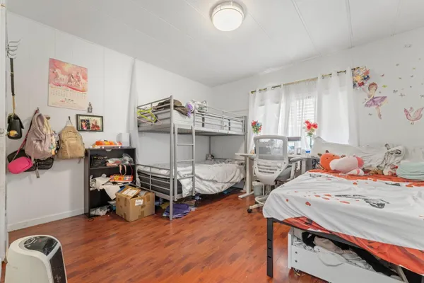 a view of a patio with table and chairs potted plants and large tree