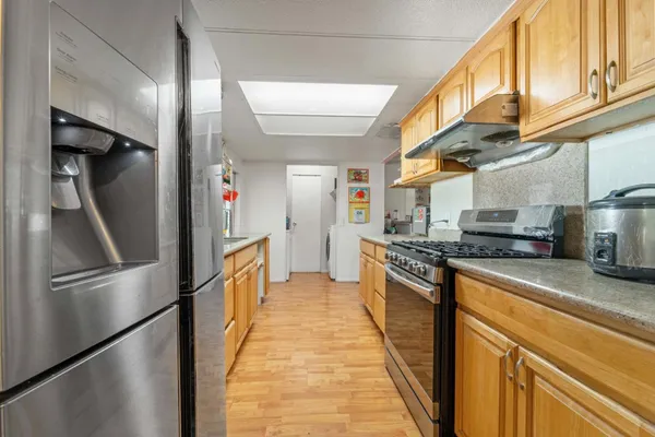 a stove top oven sitting inside of a kitchen