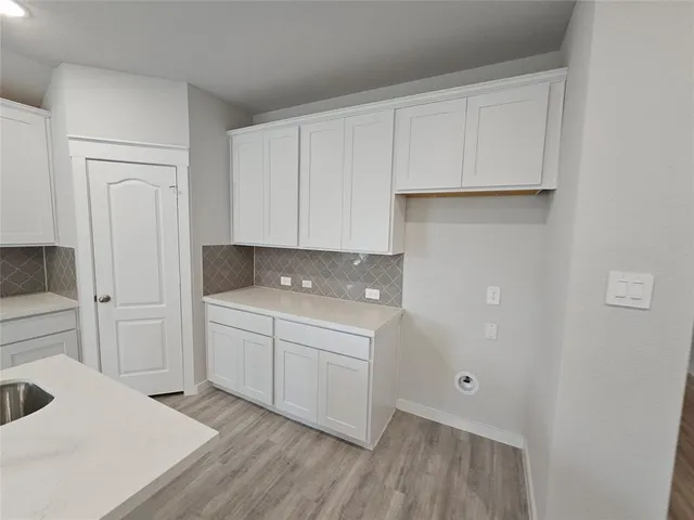 a room with a cabinets and washer dryer