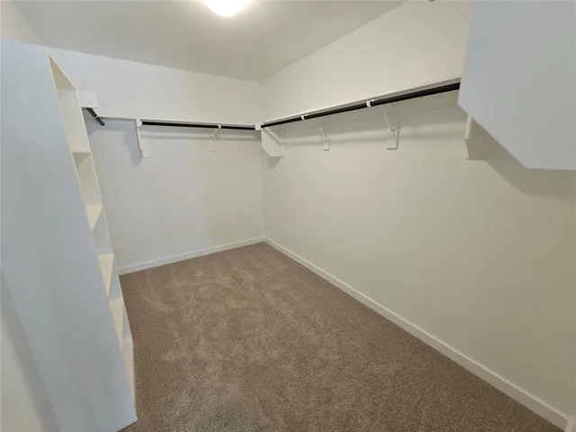 a white toilet sitting next to a white wall