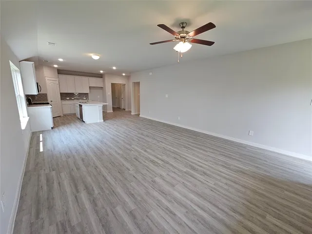 a view of kitchen with cabinets and wooden floor