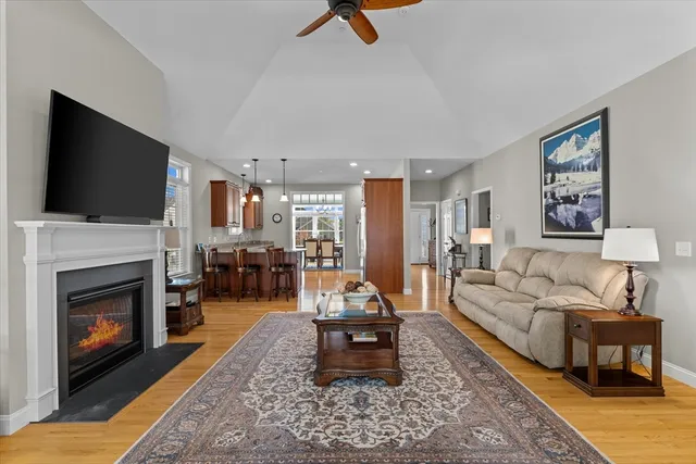 a living room with furniture a fireplace and a flat screen tv