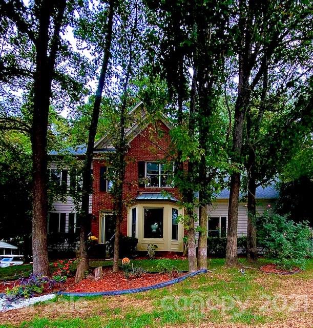 7923 Harrington Woods Road Charlotte, NC 28269 - Photo 1 of 15 a front view of a house with garden