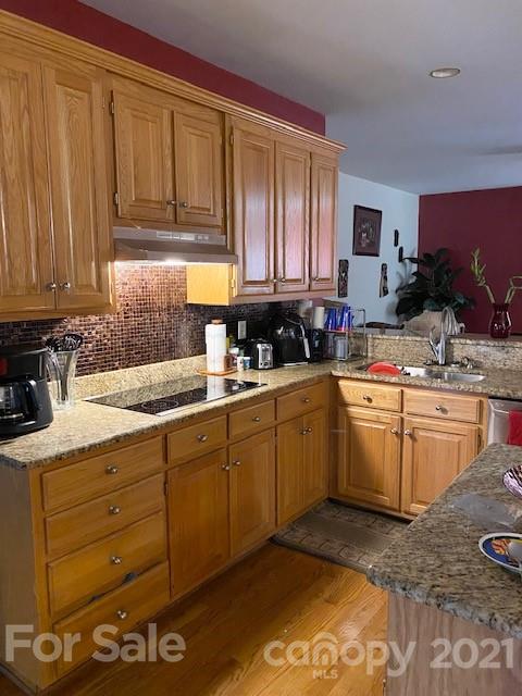 7923 Harrington Woods Road Charlotte, NC 28269 - Photo 13 of 15 a kitchen with a sink stove and cabinets