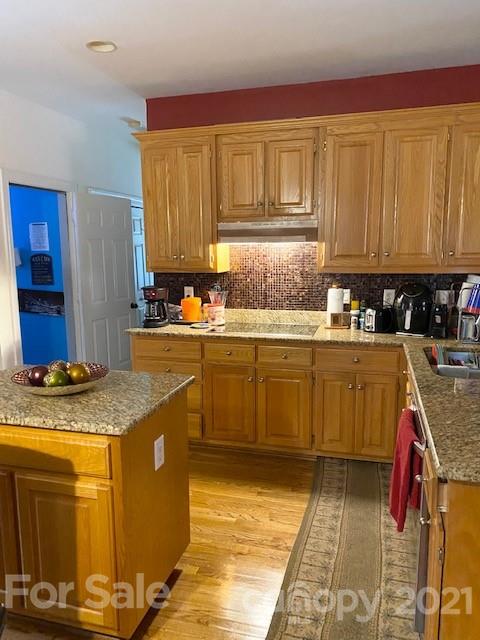 7923 Harrington Woods Road Charlotte, NC 28269 - Photo 14 of 15 a kitchen with a sink stove and cabinets