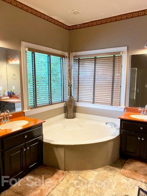 7923 Harrington Woods Road Charlotte, NC 28269 - Photo 7 of 15 a spacious bathroom with a tub sink and mirror