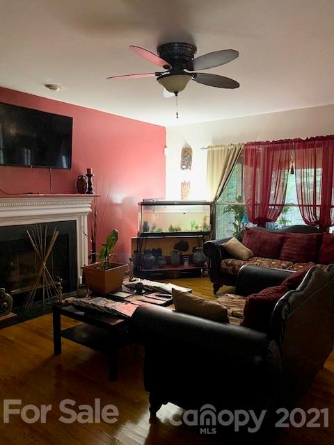 7923 Harrington Woods Road Charlotte, NC 28269 - Photo 10 of 15 a living room with furniture a flat screen tv and a fireplace