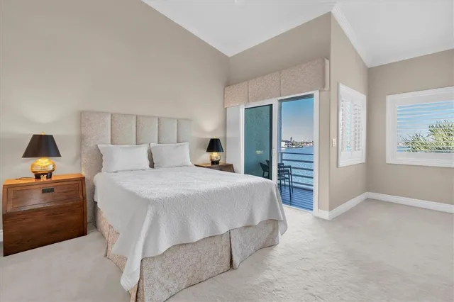 a bedroom with a bed and a lamp on dresser