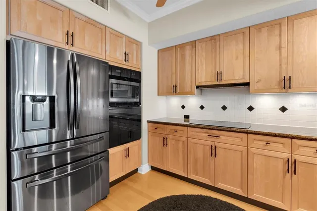 a kitchen with stainless steel appliances granite countertop a refrigerator sink and cabinets