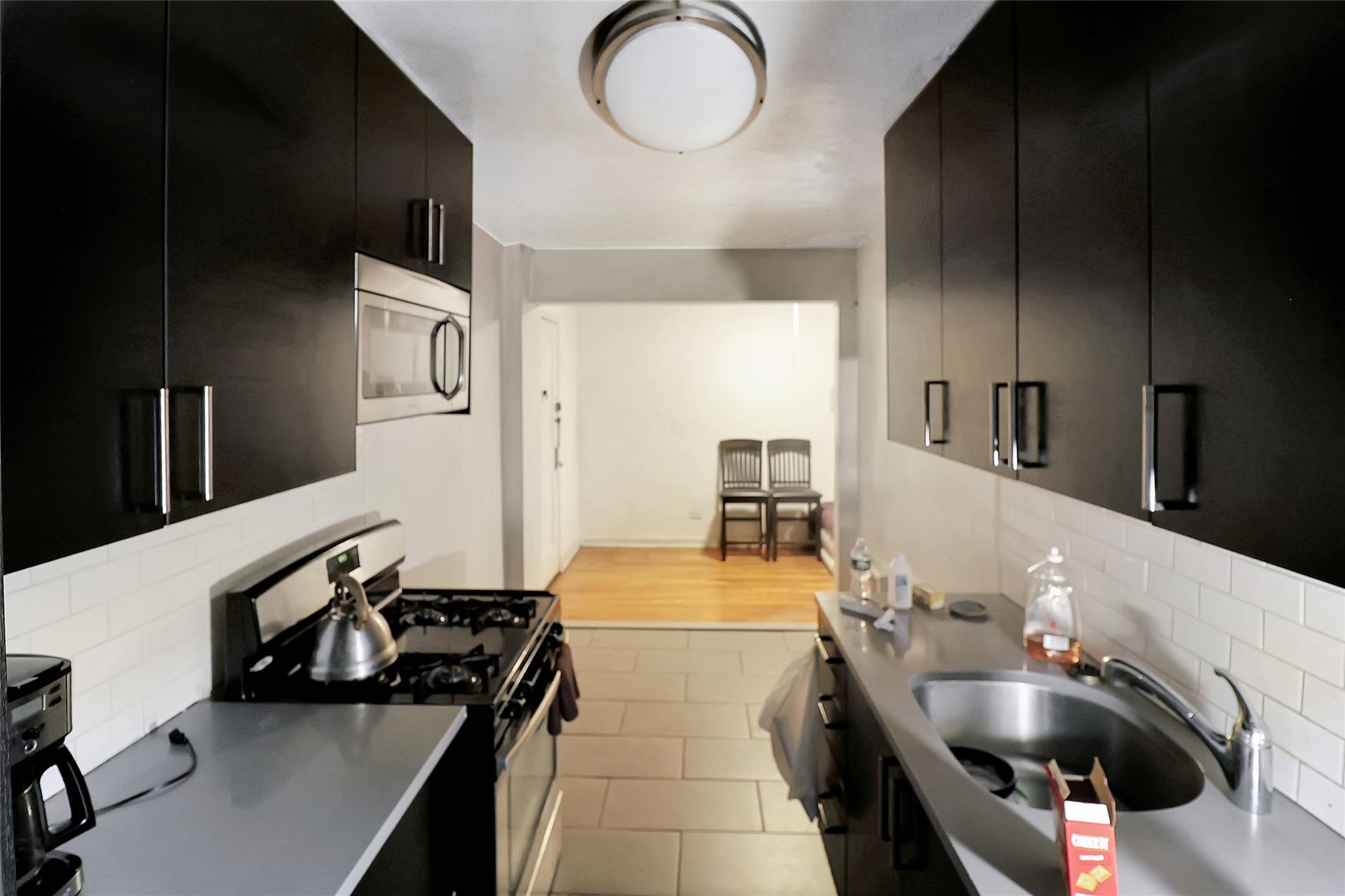 2105 Wallace Avenue, Unit 4A Bronx, NY 10462 - Photo 11 of 29 a kitchen with a sink appliances and cabinets