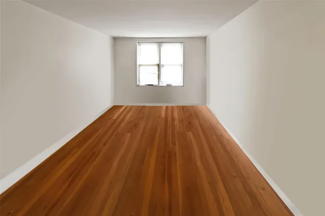 a view of a room with chairs and wooden floor