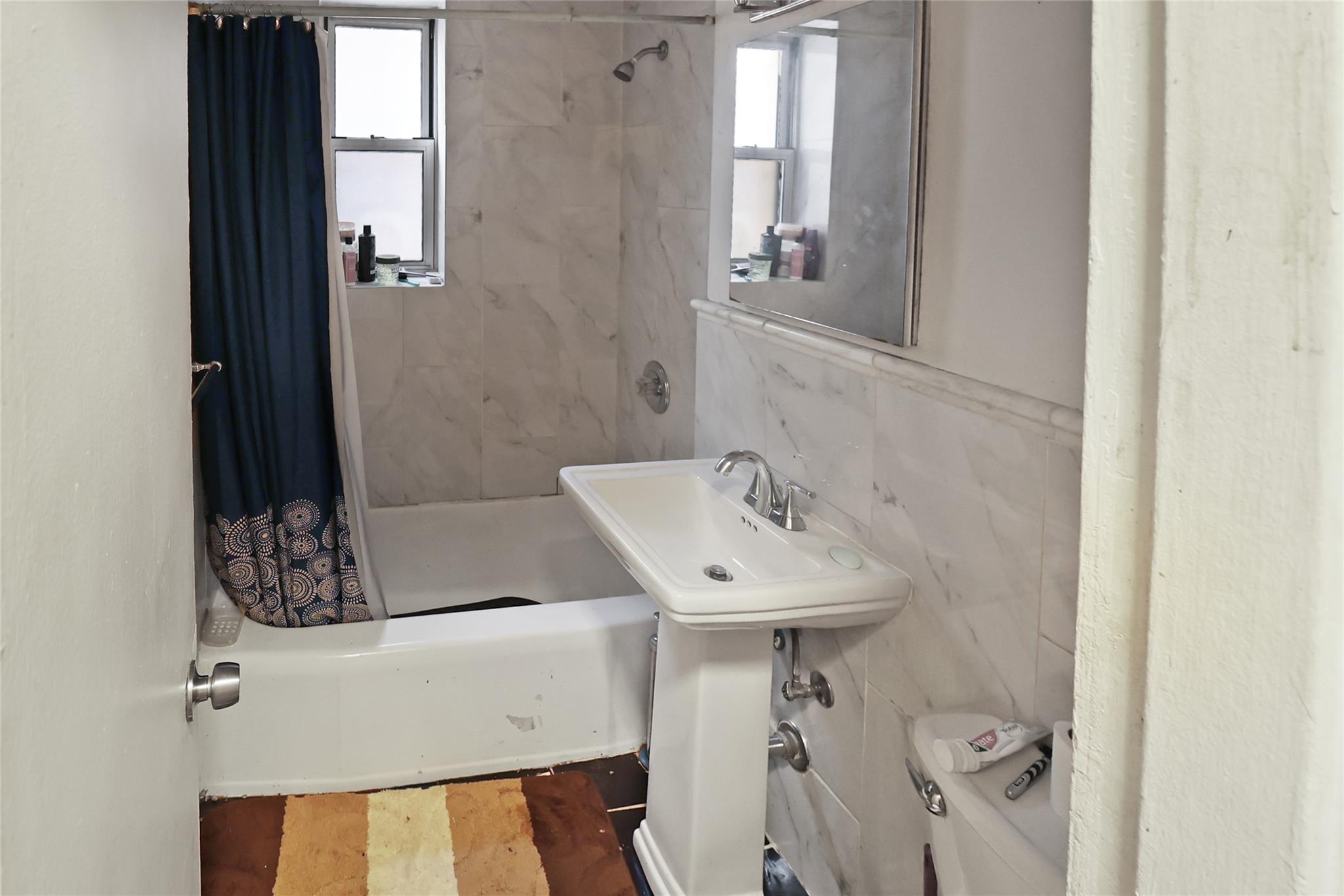 2105 Wallace Avenue, Unit 4A Bronx, NY 10462 - Photo 22 of 29 a bathroom with a sink and mirror