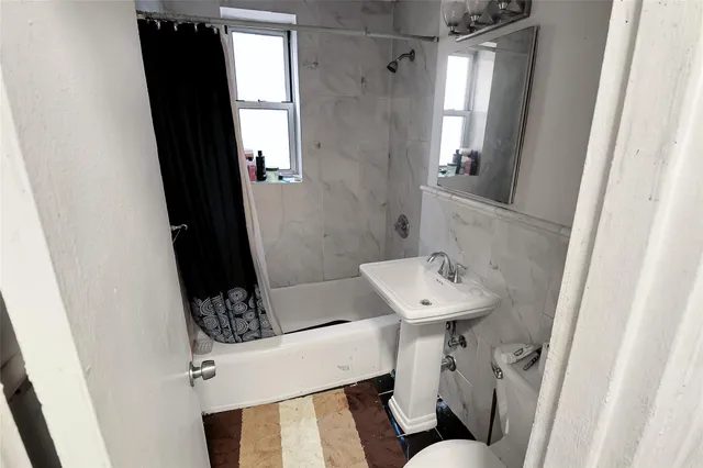 a utility room with refrigerator and washer