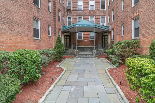 a buildings with car parked in front of it