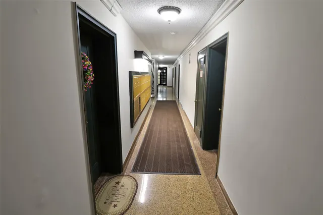 a view of hallway with wooden floor