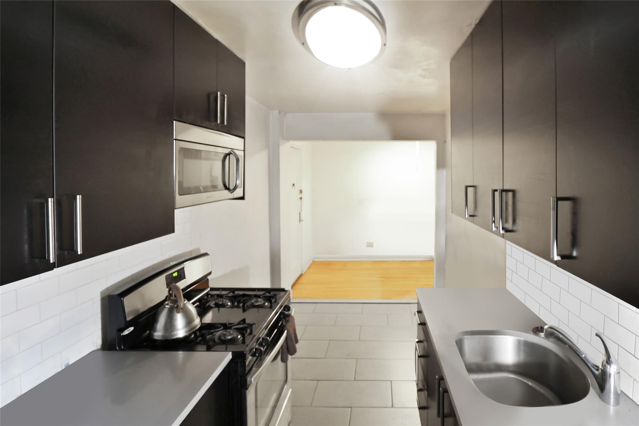 2105 Wallace Avenue, Unit 4A Bronx, NY 10462 - Photo 10 of 29 a kitchen with a stove and a sink