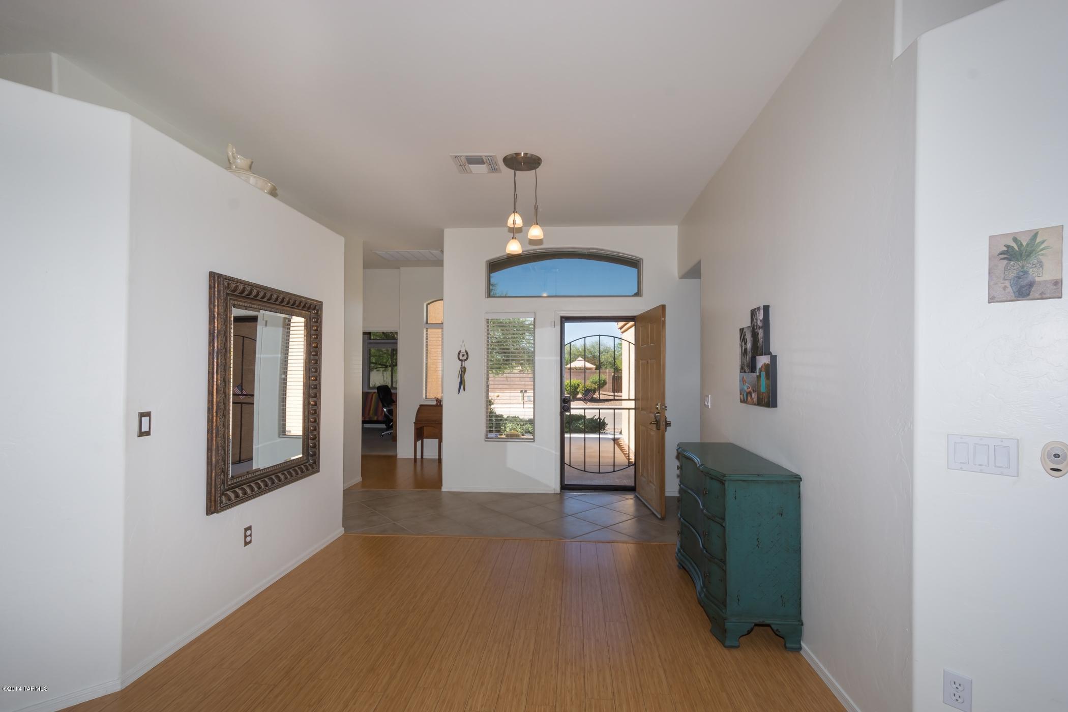 15082 North Holsteiner Road Tucson, AZ 85739 - Photo 6 of 34 a view of a livingroom with wooden floor and cabinet
