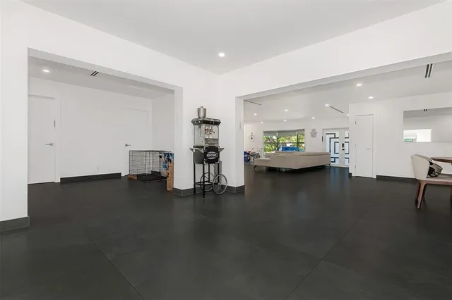 a room with a baby bed and a couch