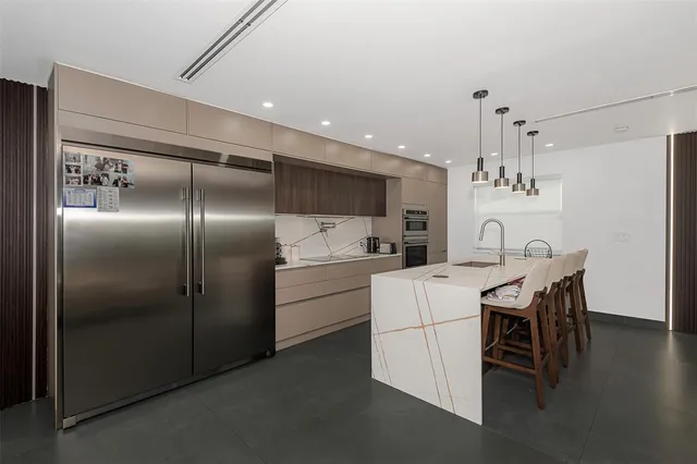 a kitchen with refrigerator cabinets and wooden floor