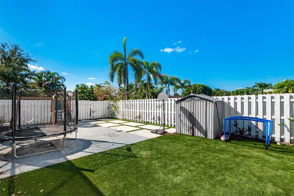5300 Garfield Street Hollywood, FL 33021 - Photo 26 of 27 a view of a backyard with a small cabin and a chair