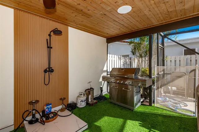 a view of a backyard with table and chairs with wooden floor and fence