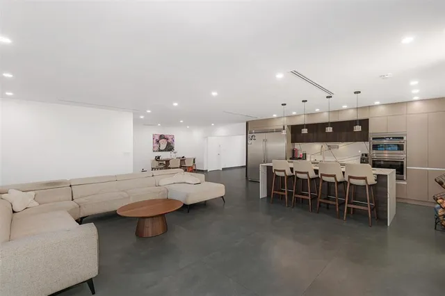 a living room with furniture and a dining table