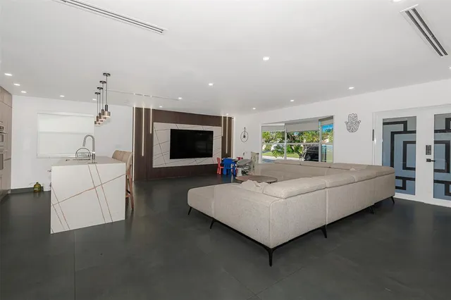 a living room with furniture and a flat screen tv