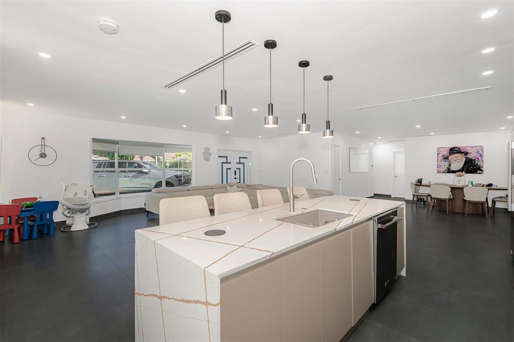 5300 Garfield Street Hollywood, FL 33021 - Photo 5 of 27 a open kitchen with stainless steel appliances kitchen island granite countertop a stove and a view of living room with furniture