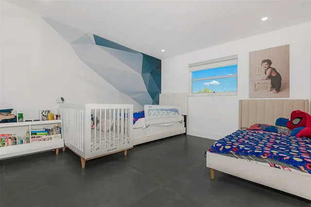 a bedroom with furniture and baby crib