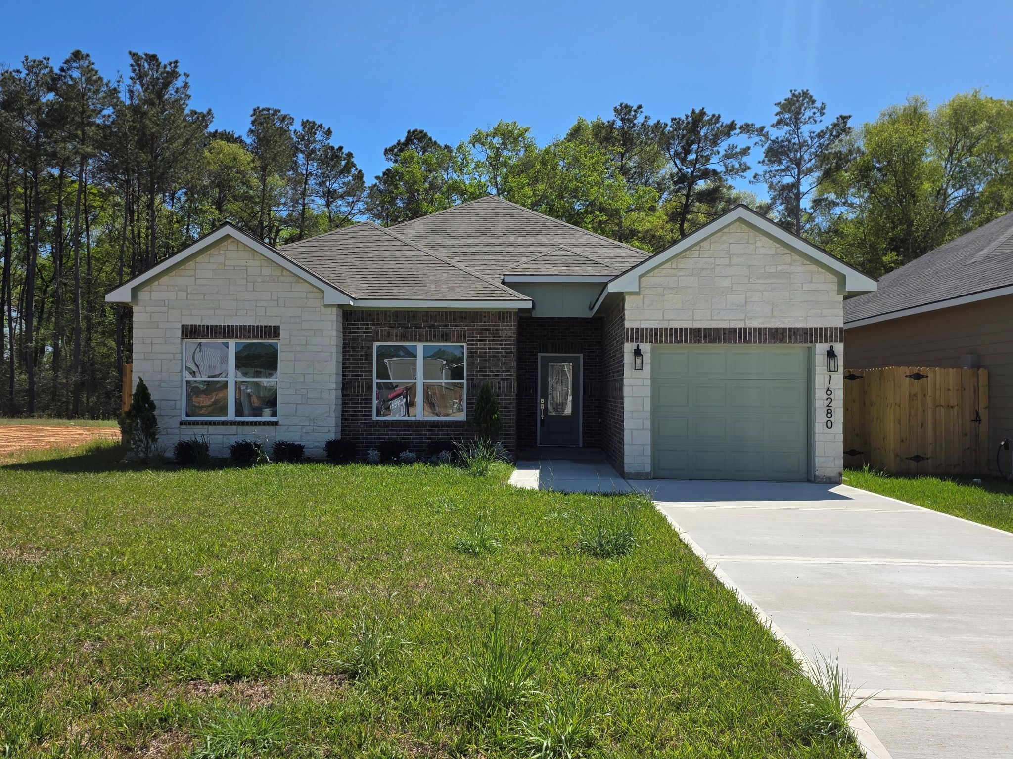 a front view of a house with a yard and trees