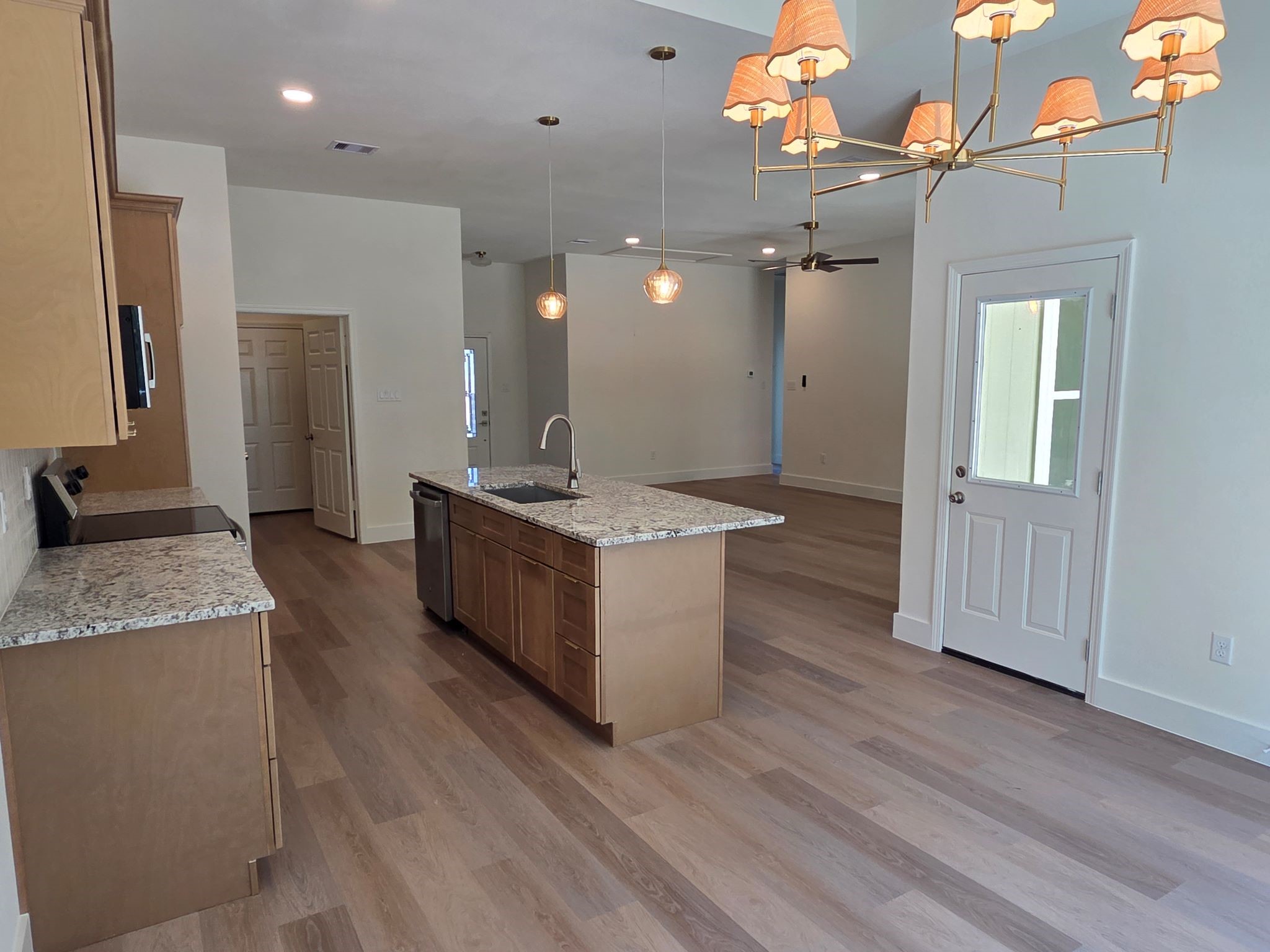 16280 Jeet Street Conroe, TX 77306 - Photo 14 of 31 a large kitchen with kitchen island a sink stainless steel appliances and cabinets