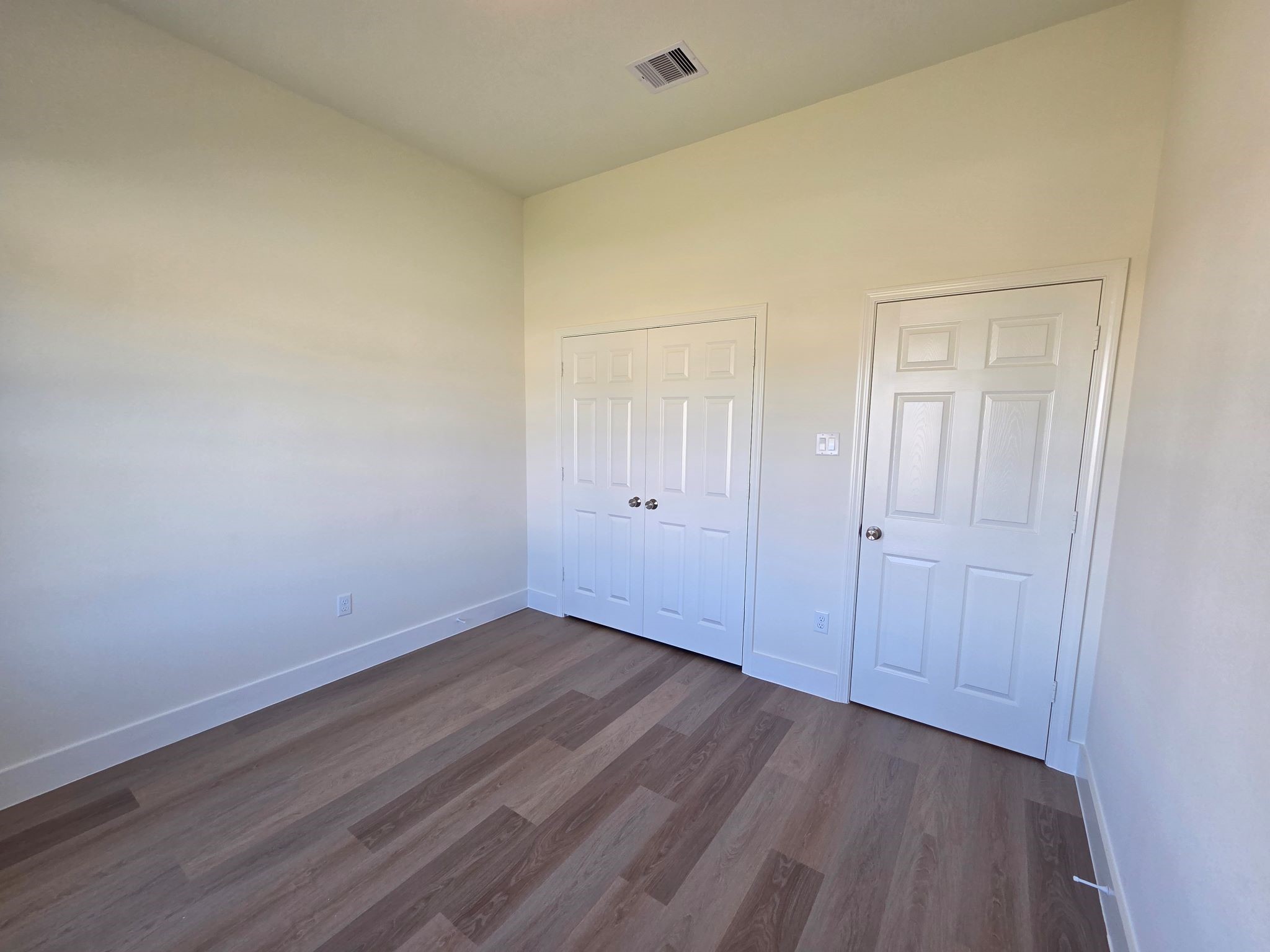 16280 Jeet Street Conroe, TX 77306 - Photo 23 of 31 a view of an empty room with wooden floor