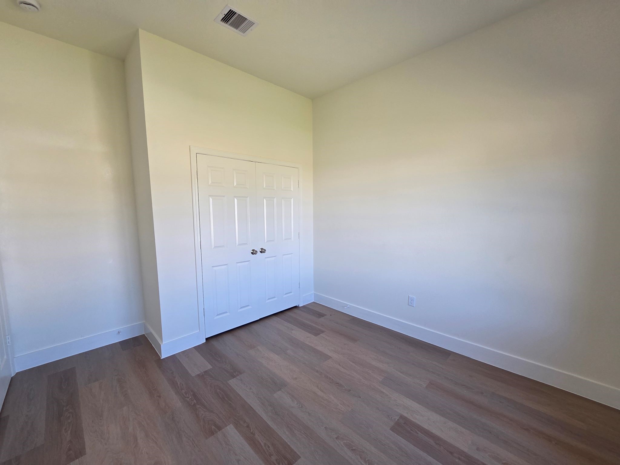 16280 Jeet Street Conroe, TX 77306 - Photo 25 of 31 a view of an empty room with wooden floor